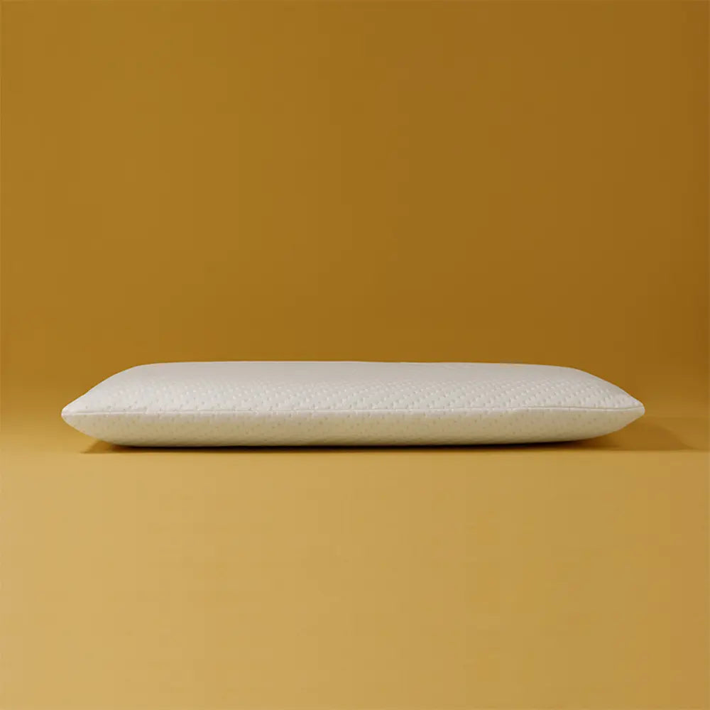 White pillow on a mustard yellow background