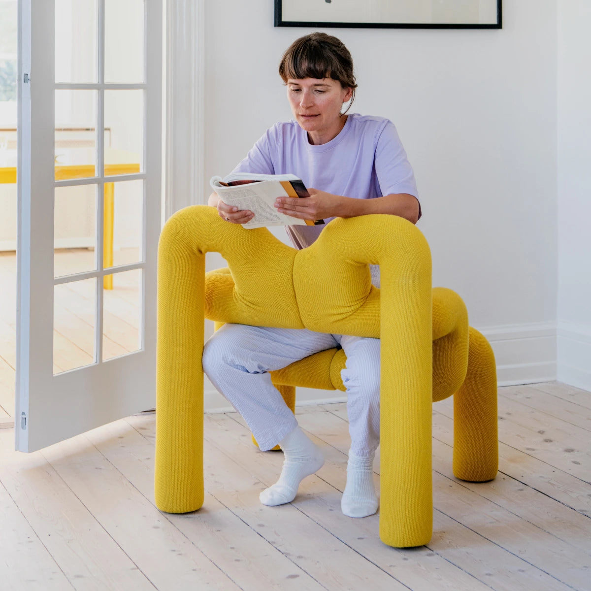 Ekstrem Chair by Varier - Yellow - Young Lady using the Chair and reading a Book