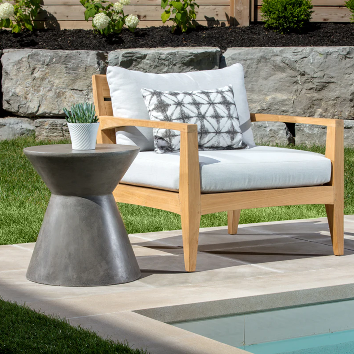 astley end table by sunpan next to a swimming pool