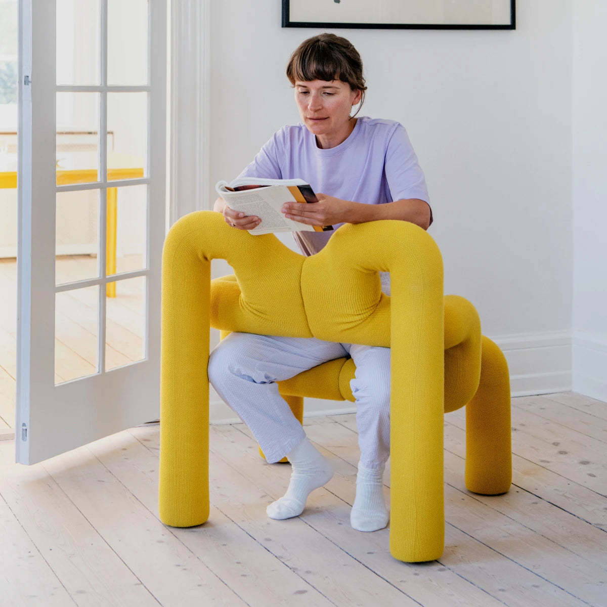 ekstrem chair by varier - yellow - young lady using the chair and reading a book